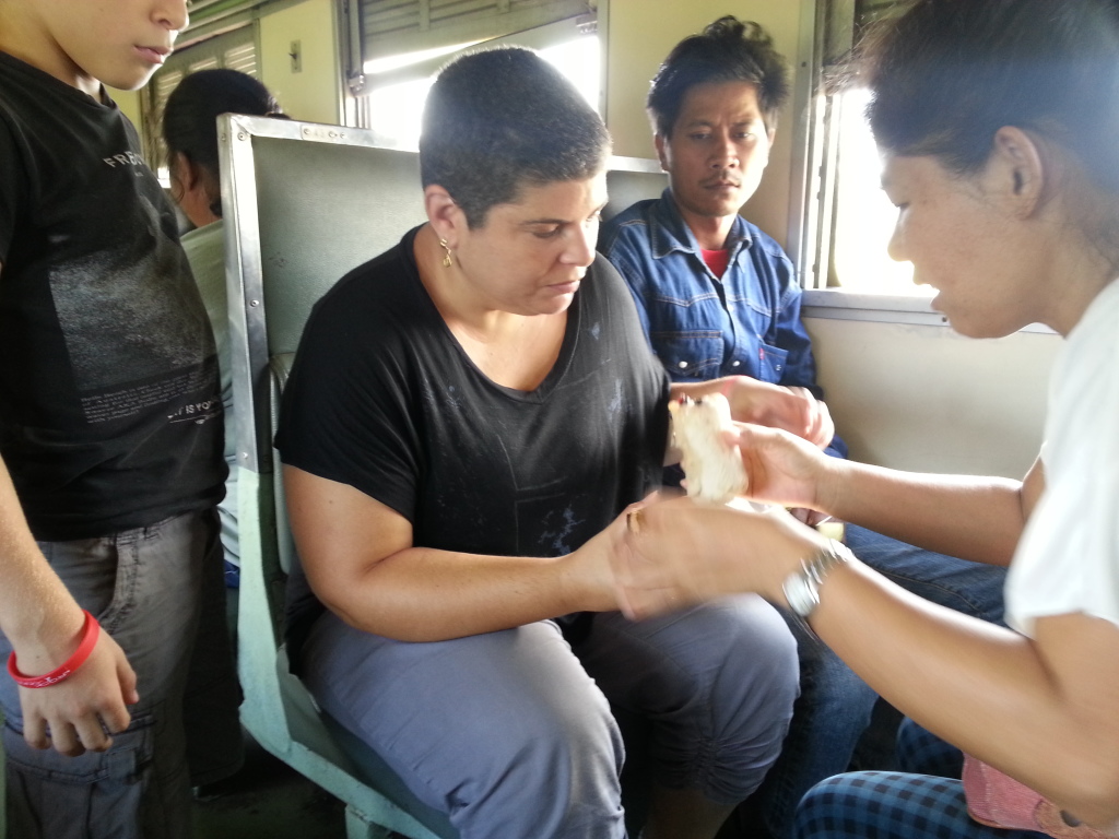 Struggling with sticky rice in bamboo stick on the train to Kanchanaburi