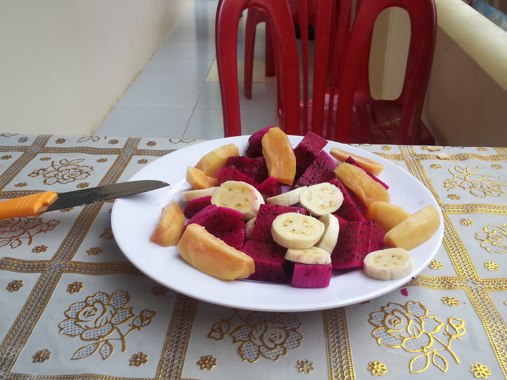 A selection of fruits - banana, sapodilla and dragon fruit