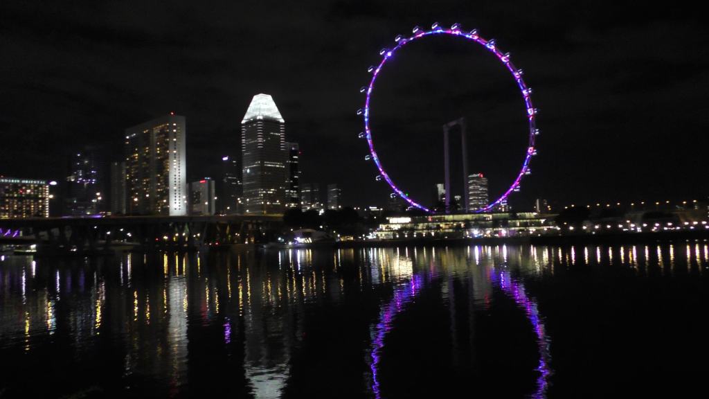 The scenic view of the city by the river at night