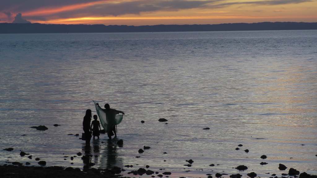 Fishermen in the sunset in Camotes, The Philippines.