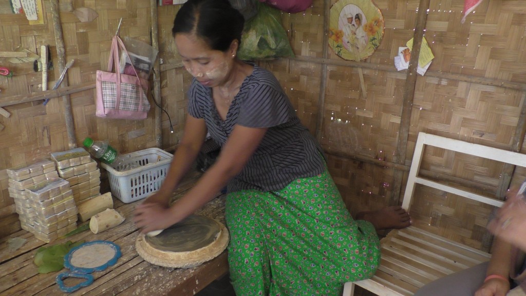 This woman is preparing Tanakha, the ubiquitous yellow make up you can see on every Burmese's face.