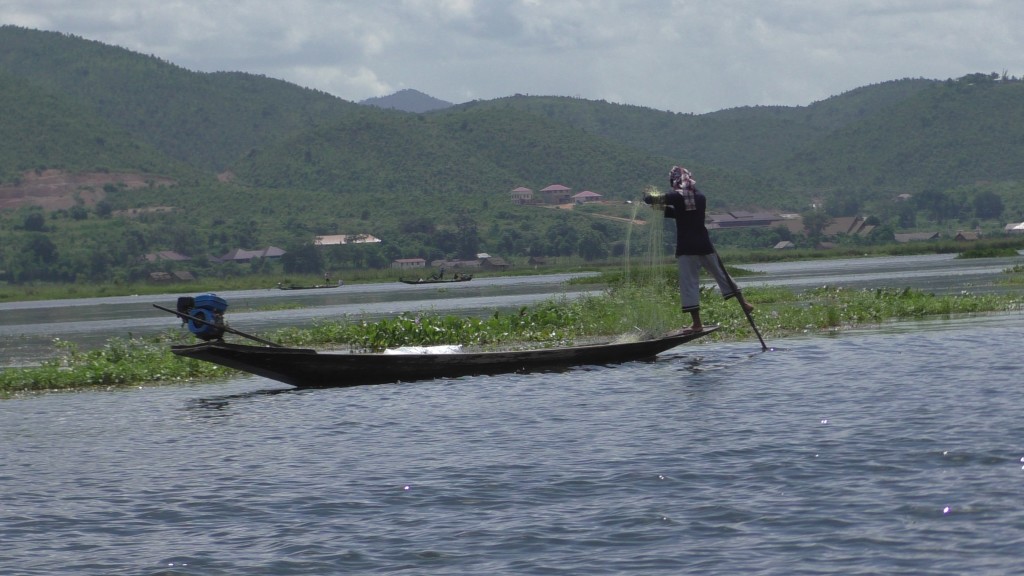 Fisherman in Inle Lake on a traditional fishing boat
